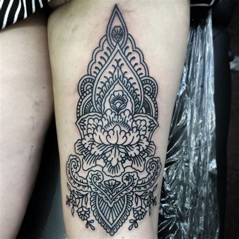 black and white thigh tattoo